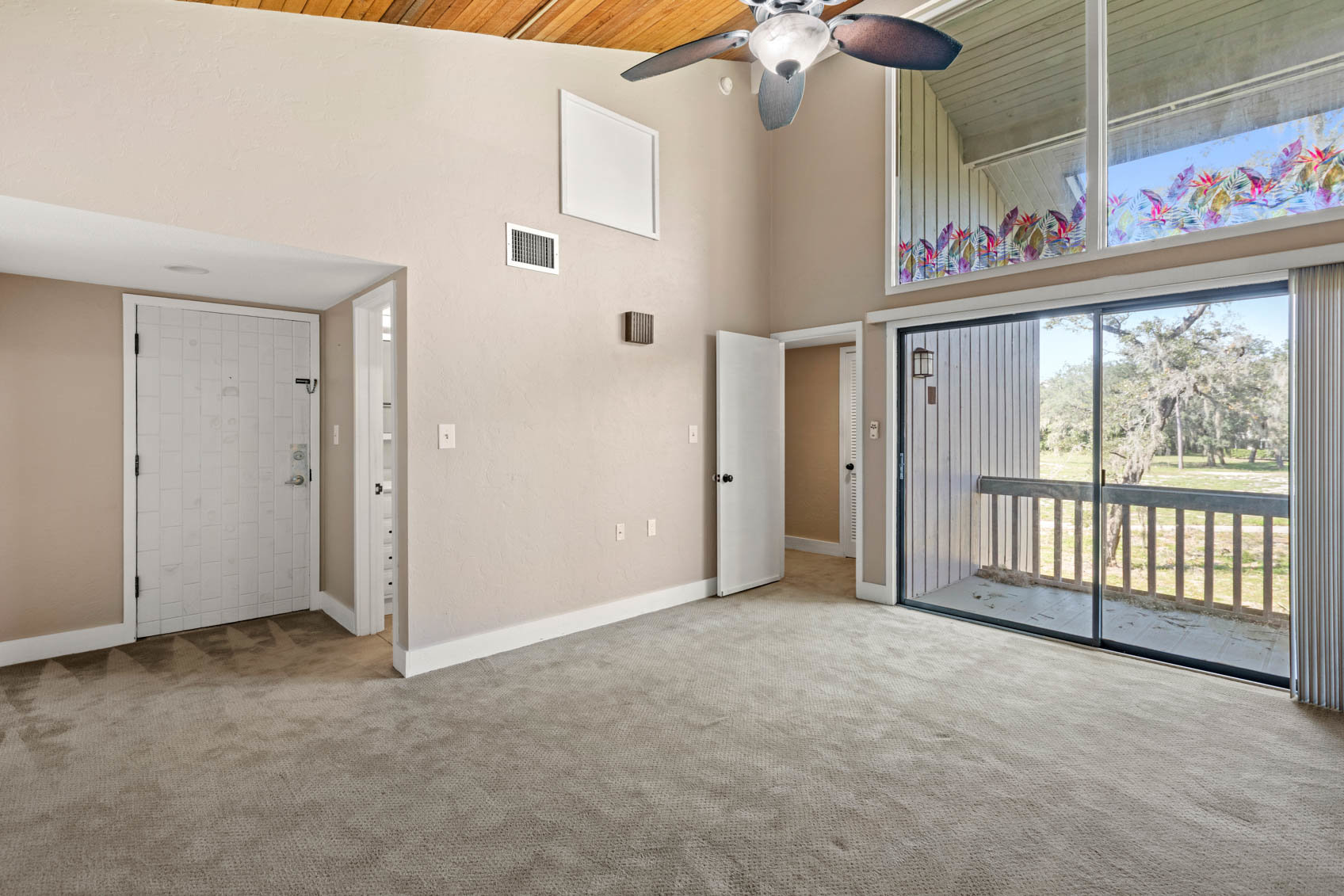 primary bedroom with no furniture and carpet with patio